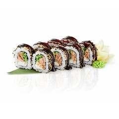Delicious sushi rolls with salmon, cucumber, cream cheese, sesame and unagi sauce drizzled on top, resting on a bamboo leaf