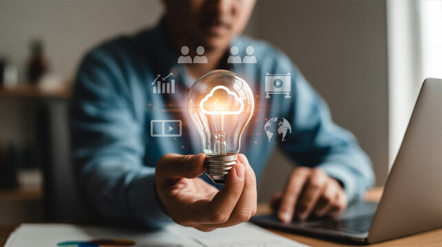 Cloud Computing Innovation A Man Holding a Light Bulb with Cloud Icon and Business Graphics for Digital Transformation