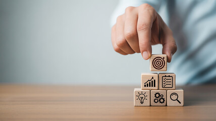 Business Strategy and Goal Setting with Wooden Blocks Stacked to Represent Objectives and Planning for Corporate Success