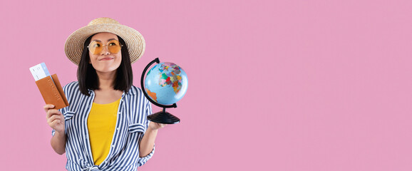 Planning Next Trip. Dreamy smiling asian female tourist holding passport with plane boarding pass...