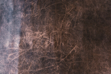 Closeup of brown distressed leather texture for vintage material background and design detail