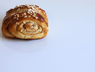 Homemade cinnamon roll on white background. Space for text.