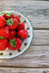 Fresh strawberries on ceramic plate