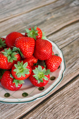 Juicy strawberries close-up on ceramic plate