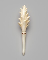 Elegant Ivory-Colored Decorative Object with Floral Design on Gray Background