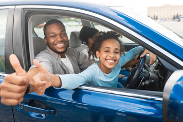 Family Approving New Car. Happy African American Father And Daughter Gesturing Thumbs Up Sitting In...