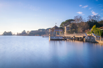 Fototapeta premium Lake Massaciuccoli, gazebo pier at sunrise. Versilia, Tuscany, Italy