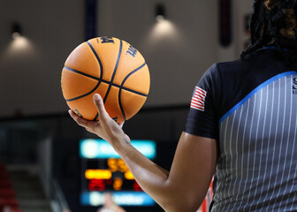 female basketball referee with ball