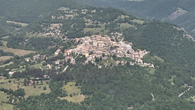 Medieval Hilltop Village of Monteleone di Spoleto in Lush Green Landscape

