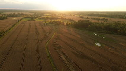 Naklejka premium Drone Horizon: Aerial Sunset Over Wheat Fields Agroculture