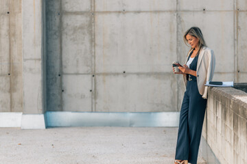 businesswoman on break with a cup of coffee and a cell phone