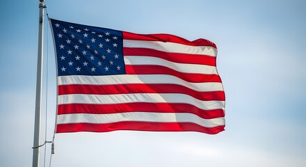 Obraz premium American flag waving proudly against a clear blue sky, symbolizing freedom, patriotism, and national pride for commercial use