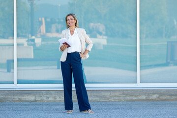 attractive businesswoman on the street full length with copy space