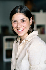 Bright Smile of a Young Woman in a Stylish Indoor Setting During Daylight