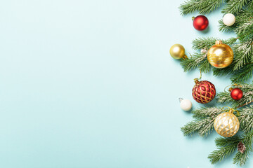 Christmas white and golden decorations on blue background with space for design.