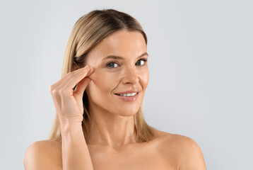 Plastic surgery, face-lift, blepharoplasty, aesthetic medicine. Closeup shot of attractive blonde...