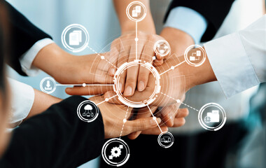 A symbolic representation of collaboration in management featuring diverse hands joining together,...