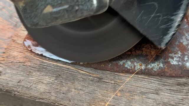 sharpening an axe with a grinder closeup. High quality 4k footage