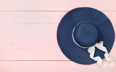 Blue beach hat on wooden background,top view