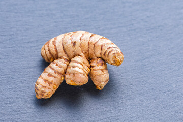 Turmeric root on a slate, close-up image, healthy food