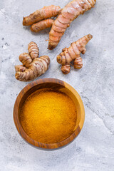 Fresh and Ground Turmeric on Rustic Background – Natural Health and Culinary Ingredient