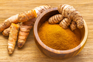 Fresh and Ground Turmeric on Rustic Background – Natural Health and Culinary Ingredient
