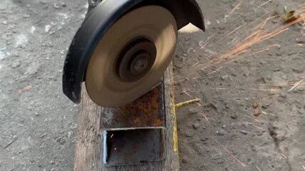 cutting metal profile pipe with a grinder. High quality 4k footage