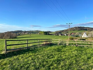 Rural landscape with meadow and wooden fence