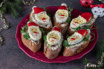 Homemade holiday sandwiches with sprats in the shape of Santa