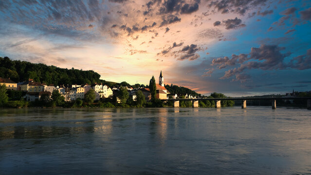 Beautiful Sunset with striking colors of homes and church building by the lake in Hallstatt Austria.