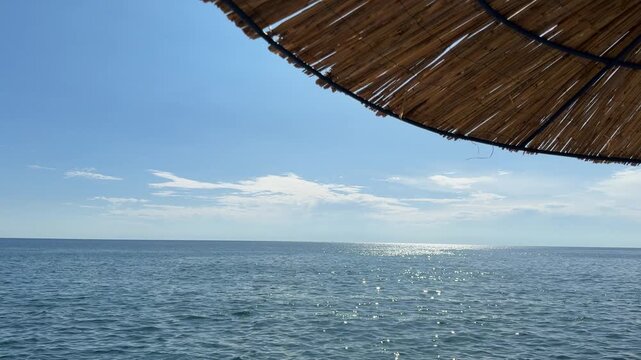 Sun parasol on the beach and blue sea.