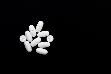 Pills or medications that are white on a black background. Anti-inflammatory pain relievers.