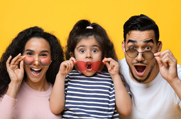 Summer Offer. Funny Excited Arab Mother, Father And Daughter Wearing Colorful Modern Sunglasses,...