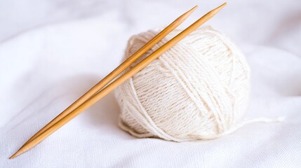 Knitting needles resting on a soft white yarn ball, showcasing the art of knitting, with a gentle texture and warm ambiance, inviting creativity and relaxation