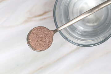 Unsweetened dark chocolate cacao powder in the spoon	