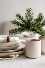 minimalist christmas table elegantly decorated with natural materials and fresh pine branches