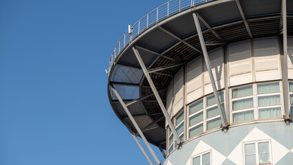 Close-up of industrial tower top with metal supports and windows