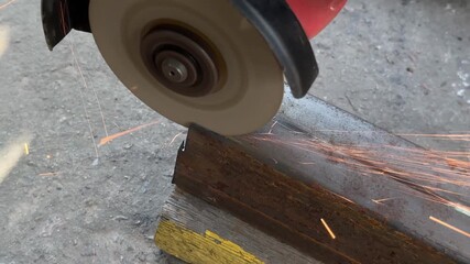 cutting a groove in a metal profile pipe using a grinder. High quality 4k footage