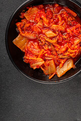 Kimchi pickled cabbage salad spicy savory vegetables fresh delicious gourmet food background on the table rustic food top view copy space vegetarian and vegan food
