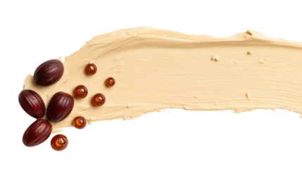 Jojoba oil seeds and a smear of cosmetic cream isolated on transparent background