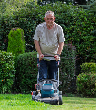 man cutting the grass with a mower