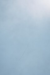 Light Blue Plaster Wall with Fine Cracks and Gradient Texture
