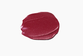 Cosmetic beauty make up product swatch sample . Lipstick smudge dark red cherry colored isolated on grey background
