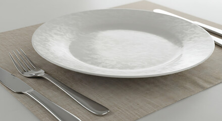White ceramic plate with stainless steel fork and knife on linen placemat