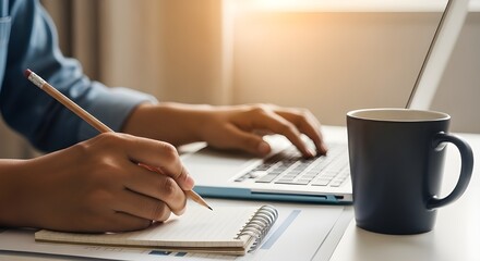 Remote worker planning strategy with laptop and coffee cup