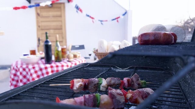 Chilean Independence Day video: Woman places anticuchos on grill during traditional celebration with decorated terrace in background