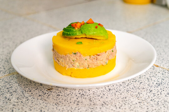 Causa limena, peruvian food, featuring tuna, avocado, and yellow potatoes