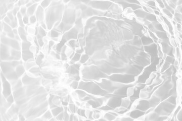White water with ripples on the surface. Defocus blurred transparent white colored clear calm water surface texture with splashes and bubbles. Water waves with shining pattern texture background.