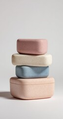 Stacked pastel eco-friendly containers, studio shot, white background, sustainable packaging