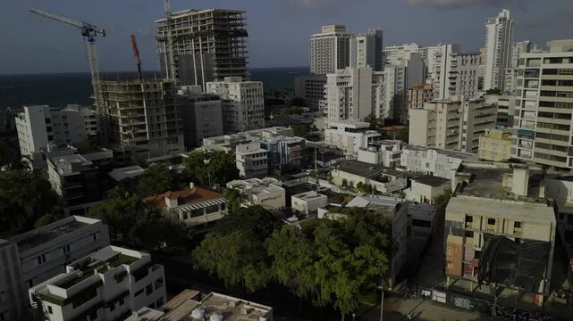 Drone flies up and way from Condado neighborhood in the late afternoon in San Juan, Puerto Rico